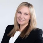 a woman in a business suit posing for a picture.