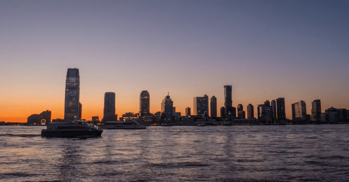 a large body of water with a city in the background.