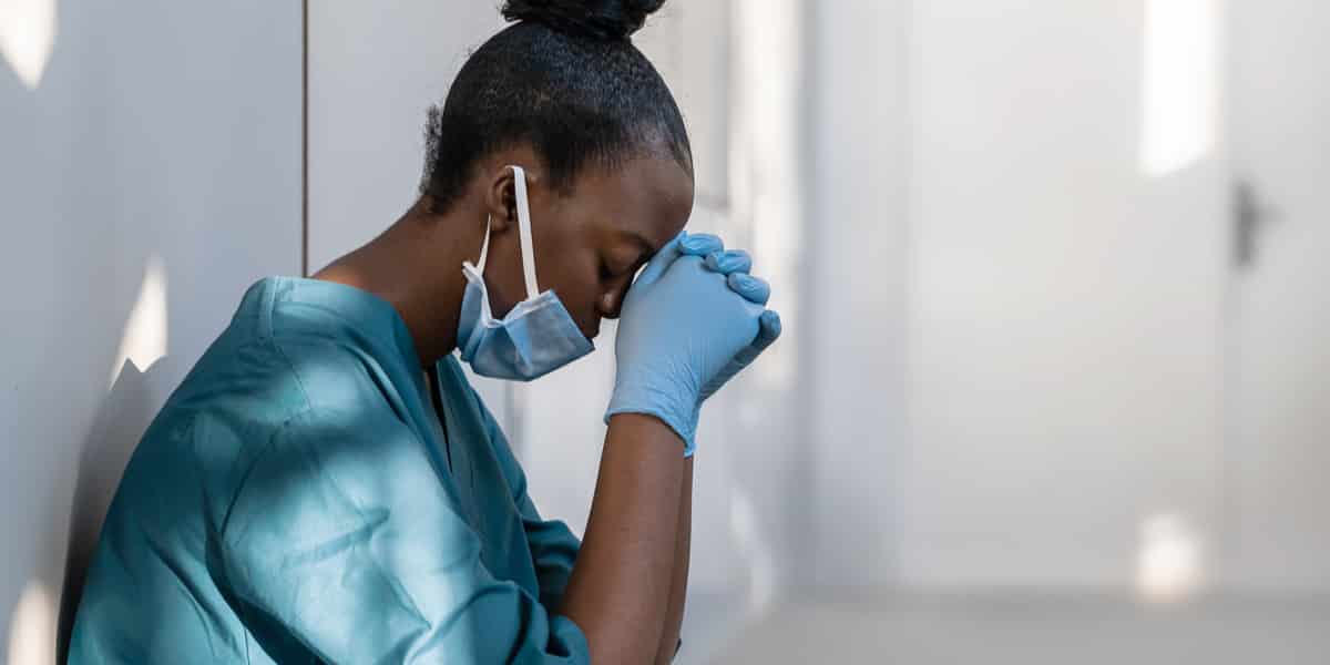 a woman wearing a surgical mask and gloves.